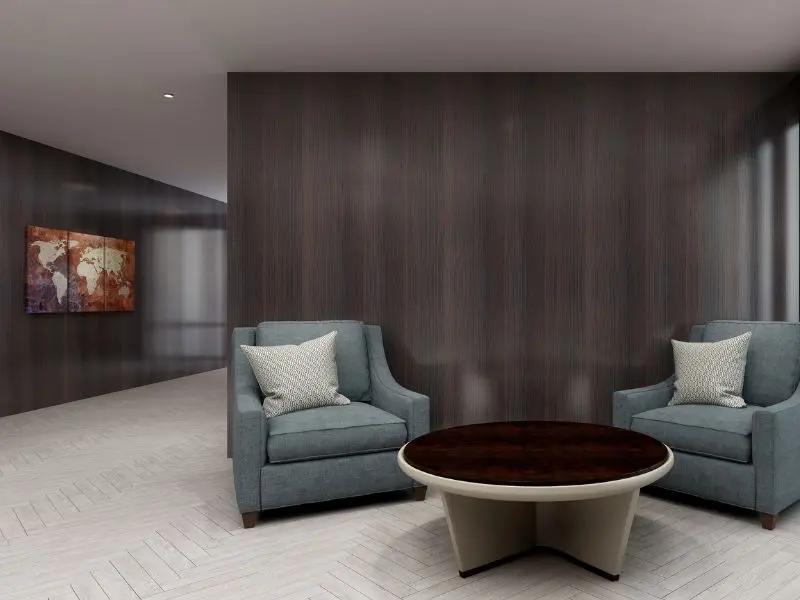 Modern lounge with two chairs, round table, and light ceramic tiled floor.