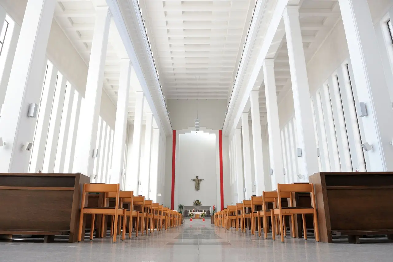 Clean church interior with polished floors, wooden pews, and natural light maintained by church cleaning services.