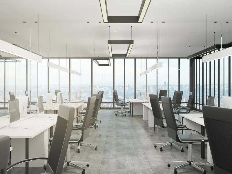 Spacious modern corporate office with clean desks, ergonomic chairs, and panoramic city views—ideal for business productivity and professionalism.