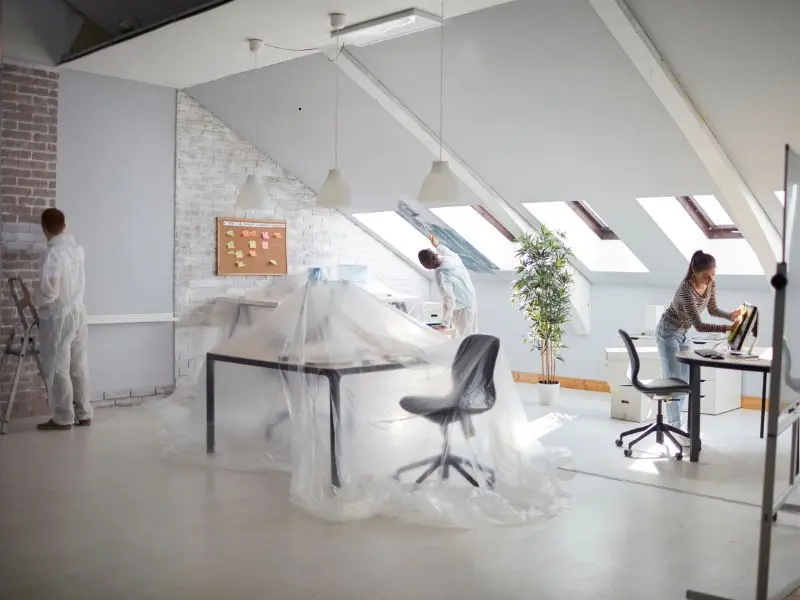 Team cleaning and preparing renovated office space after construction work
