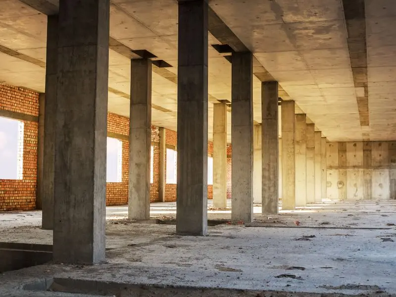 Unfinished building floor with dust and debris before post-construction cleanup
