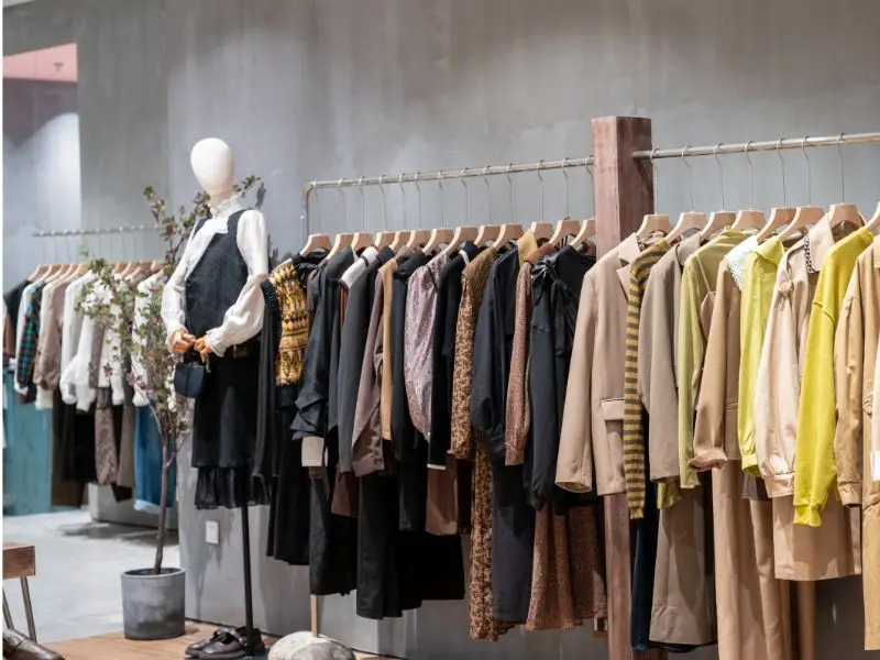 Fashion boutique with neatly arranged clothing racks and spotless floors from retail store cleaning services.
