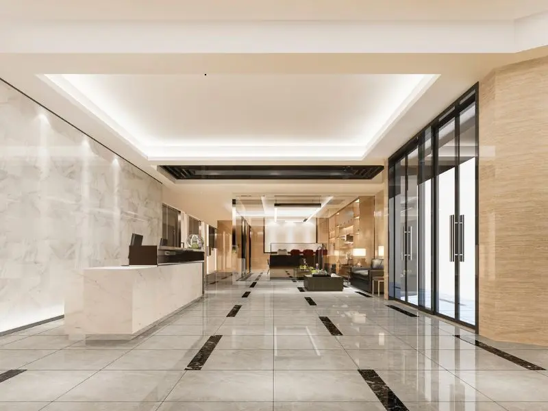 Polished hotel lobby with glossy tile floors and modern interior design.