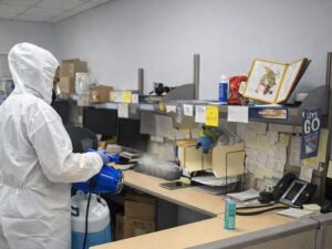 Technician applying advanced disinfection solutions for businesses with professional spraying equipment.
