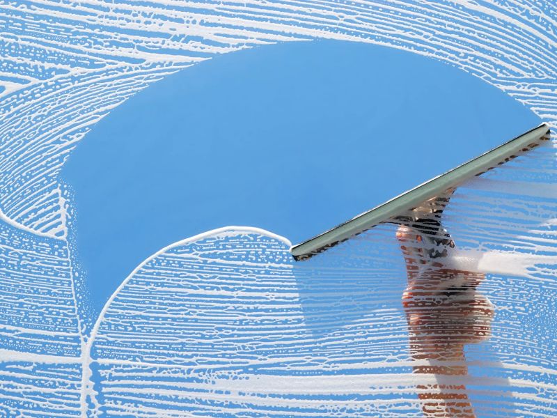 How often should windows be professionally cleaned for commercial properties?